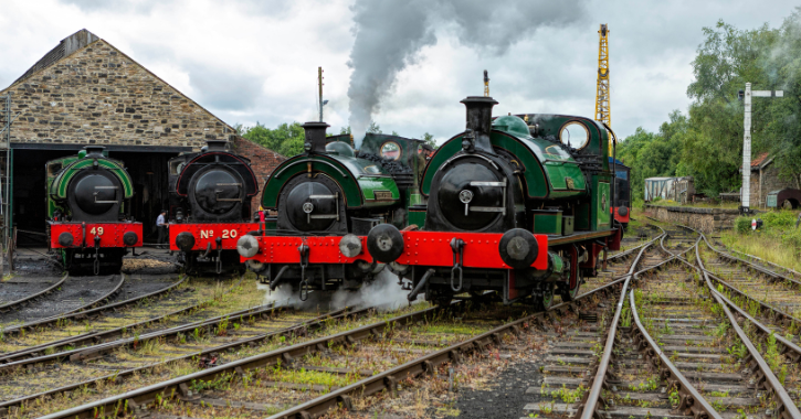 Four historic steam engines parked in front of Marley Hill engine shed at Tanfield Railway.